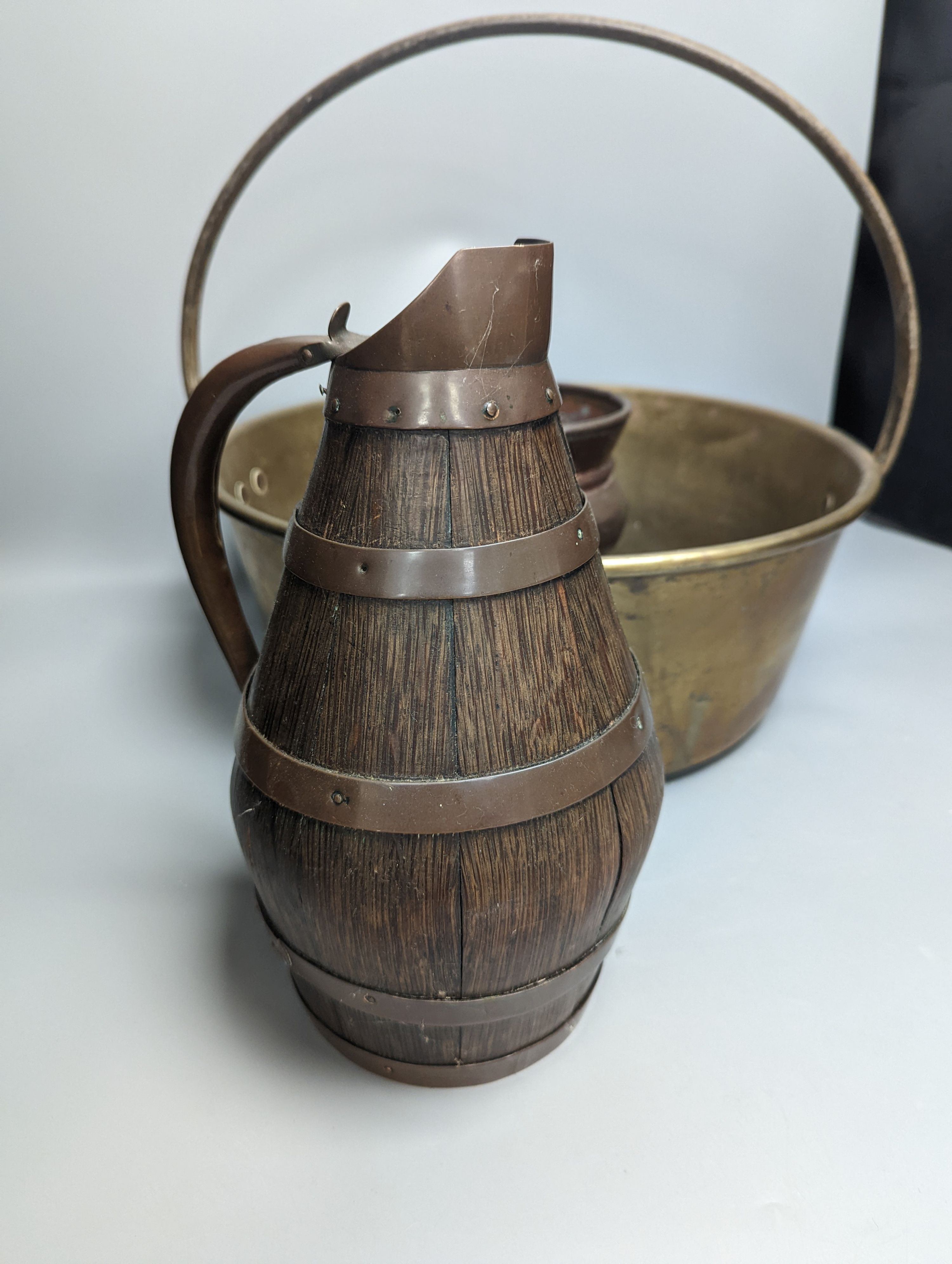 A studded copper pail, a coopered oak jug and other copper and brass wares , coopered jug 28cm high